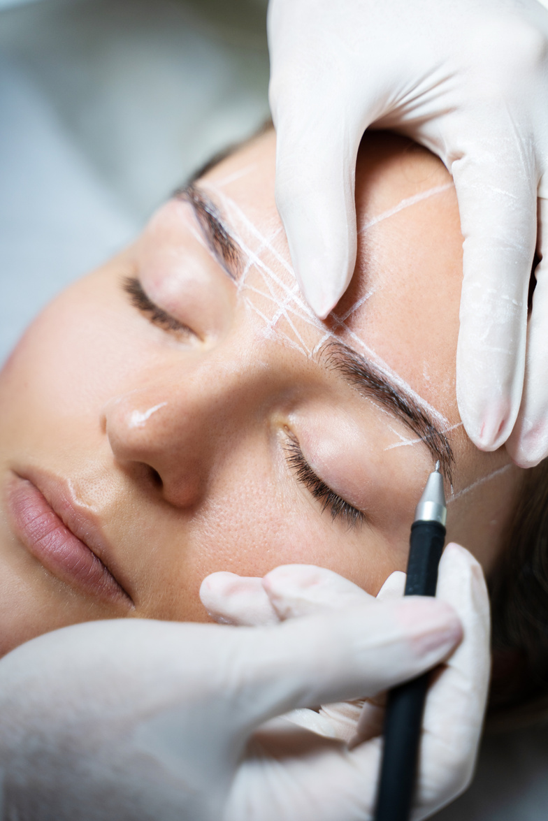 Woman during Professional Eyebrow Mapping Procedure